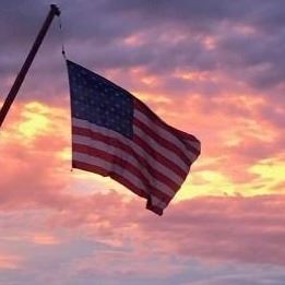 American Flag with sunset in background